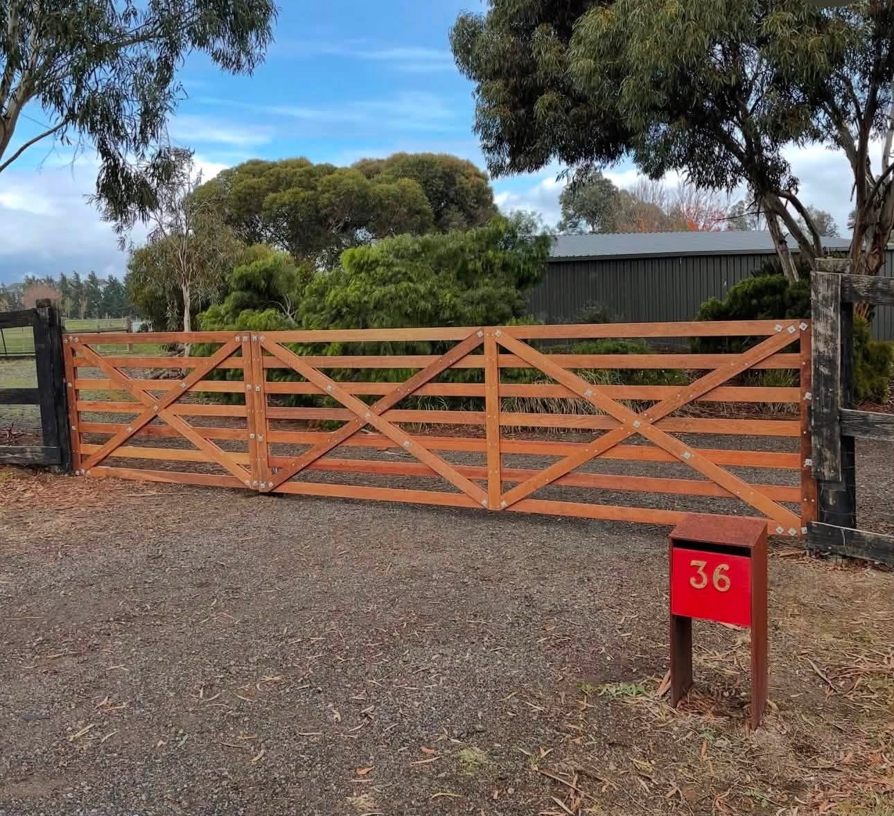Wide timber rural entrance gates with diagonal bracing